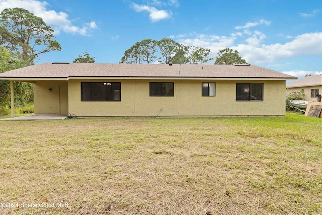 rear view of property with a yard and a patio