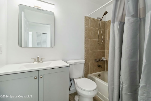 full bathroom featuring vanity, shower / bathtub combination with curtain, and toilet