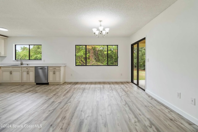 interior space with a notable chandelier, a healthy amount of sunlight, light hardwood / wood-style floors, and sink