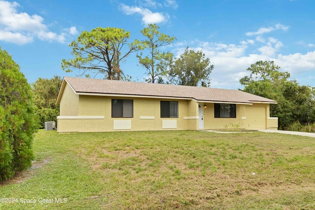 single story home featuring a garage and a front lawn