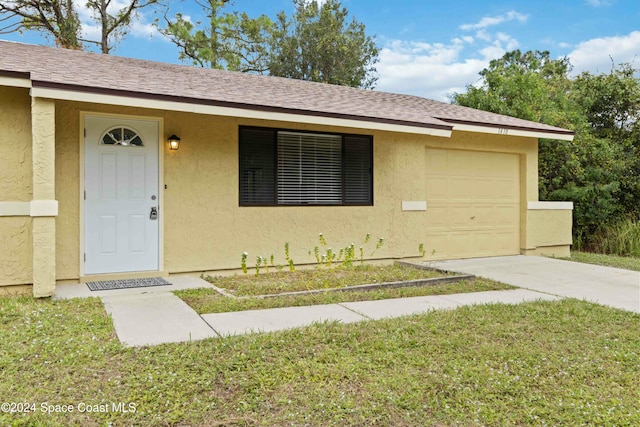 view of front of house with a front yard and a garage