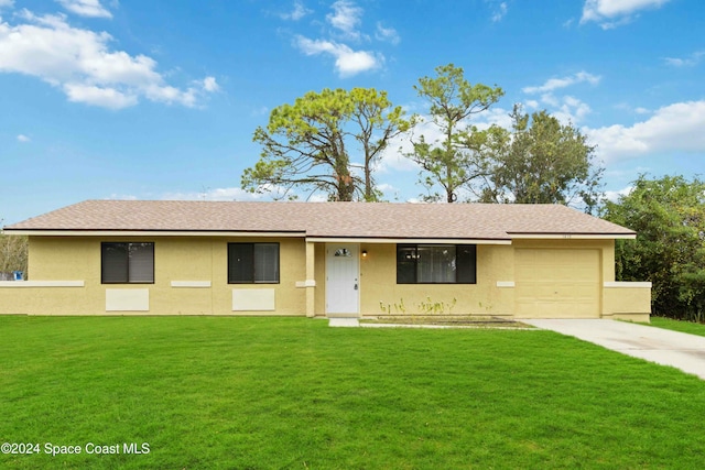 ranch-style home with a front yard and a garage