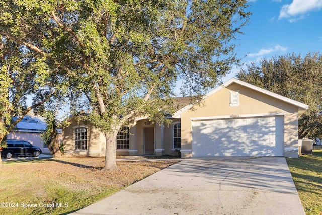 single story home featuring central air condition unit and a garage