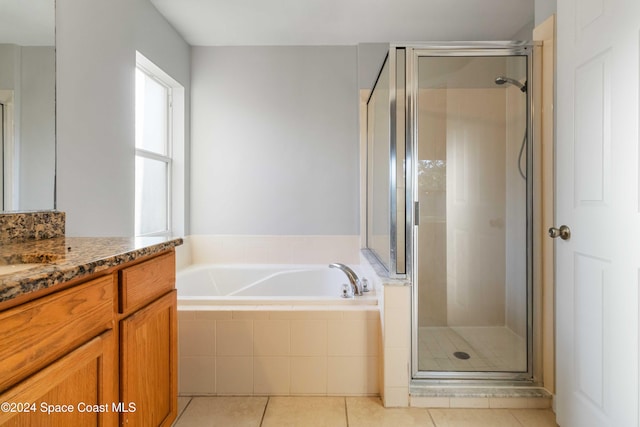 bathroom with tile patterned floors, vanity, and independent shower and bath