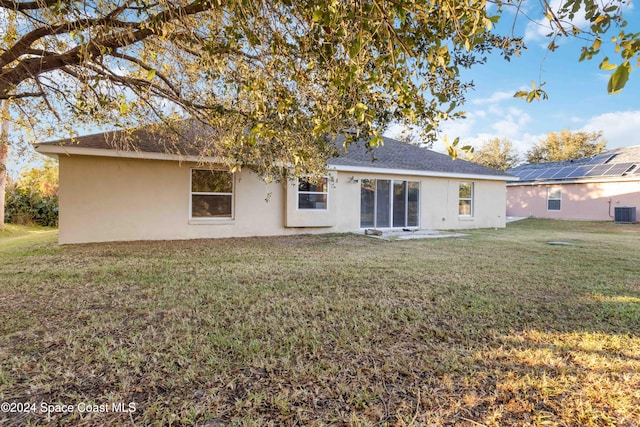 rear view of property with a lawn