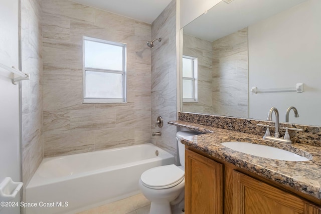 full bathroom with a wealth of natural light, vanity, tiled shower / bath combo, and toilet