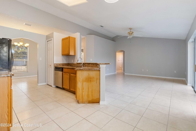 kitchen featuring black fridge, ceiling fan with notable chandelier, stainless steel dishwasher, and lofted ceiling