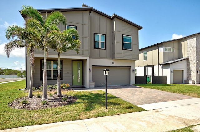 view of front of property with a garage and a front lawn