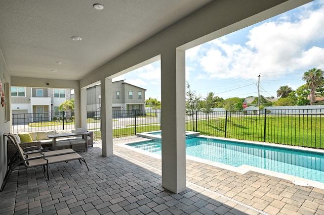 view of swimming pool with an in ground hot tub, a patio, and a lawn