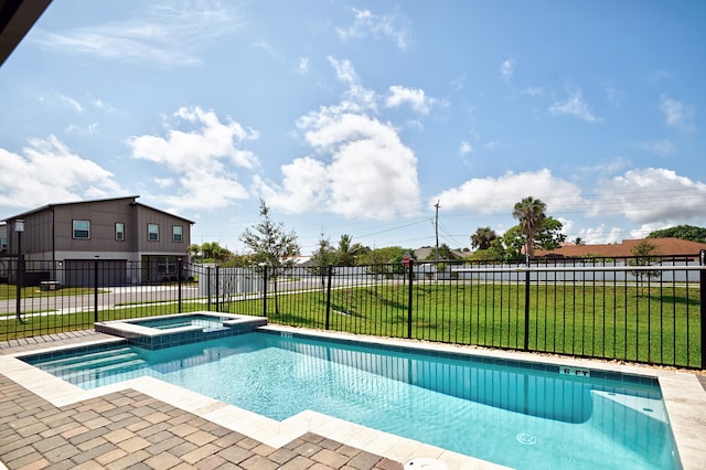 view of swimming pool with a lawn and an in ground hot tub