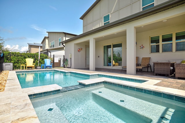 view of pool with an in ground hot tub and a patio area