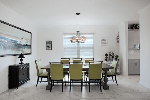 dining area with crown molding and an inviting chandelier