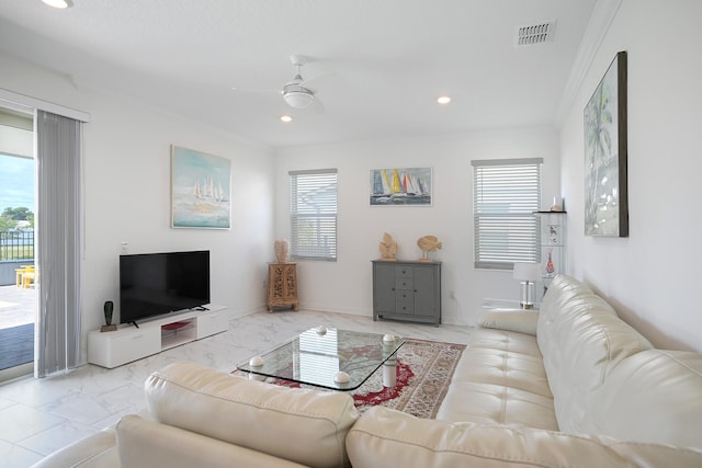 living room with crown molding, ceiling fan, and a healthy amount of sunlight