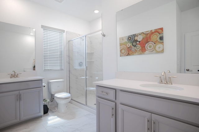 bathroom featuring vanity, toilet, and a shower with door