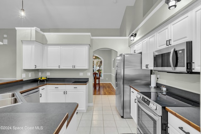 kitchen featuring white cabinetry, light tile patterned floors, and stainless steel appliances