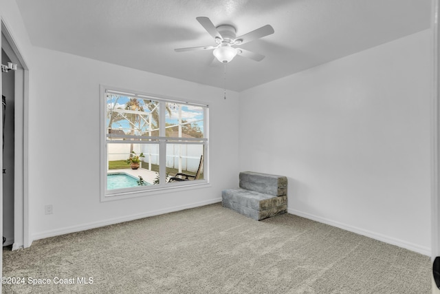 unfurnished room featuring ceiling fan and light colored carpet