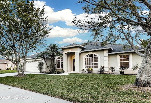 view of front of house with a front lawn and a garage