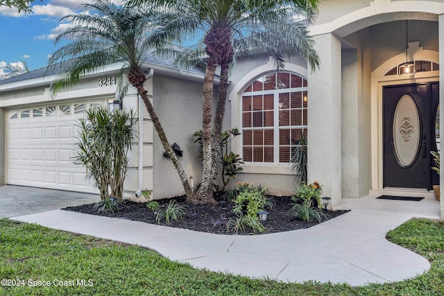 view of exterior entry with a garage