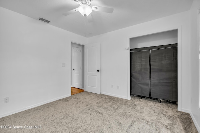 unfurnished bedroom with ceiling fan, a closet, and light colored carpet