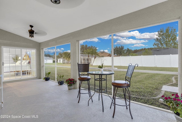 sunroom with vaulted ceiling and ceiling fan