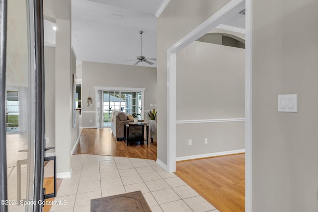 foyer featuring light hardwood / wood-style flooring, ceiling fan, and crown molding