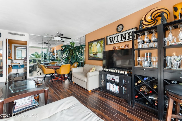 living room featuring ceiling fan and dark hardwood / wood-style floors