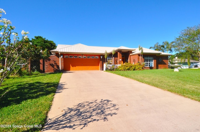 ranch-style house featuring a garage and a front lawn