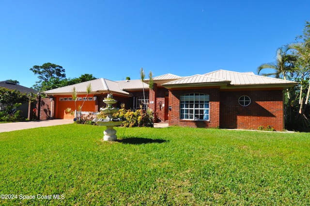 single story home featuring a front yard and a garage