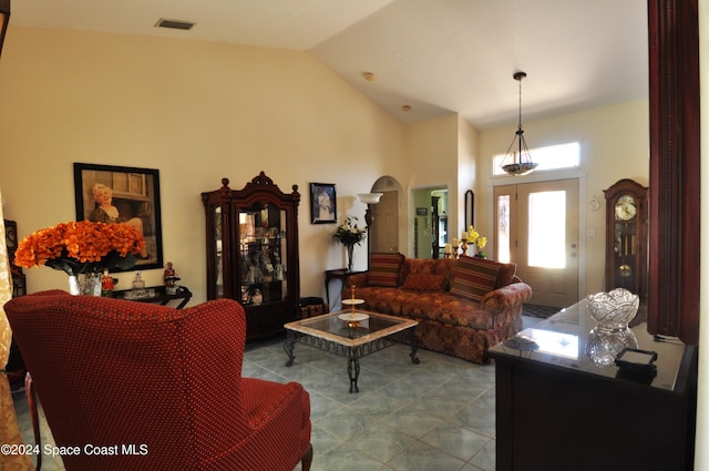 living room featuring high vaulted ceiling