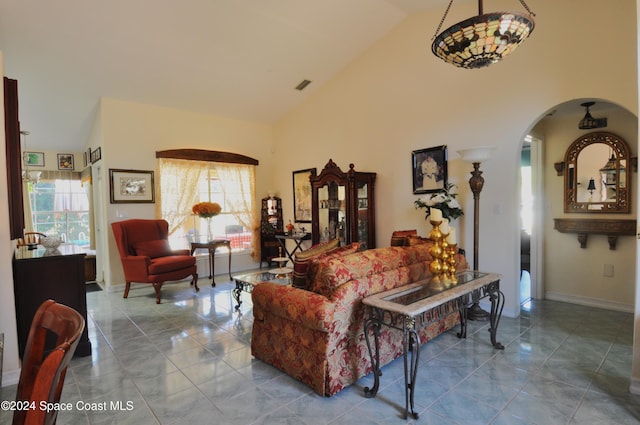 living room featuring tile patterned floors, high vaulted ceiling, and a healthy amount of sunlight