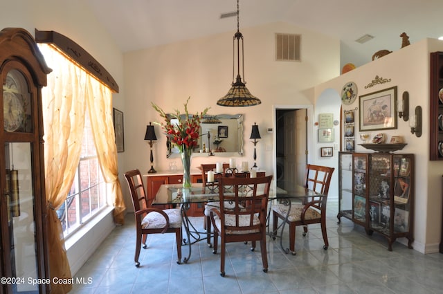 tiled dining area with lofted ceiling