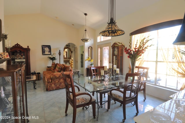 dining room with lofted ceiling and light tile patterned floors