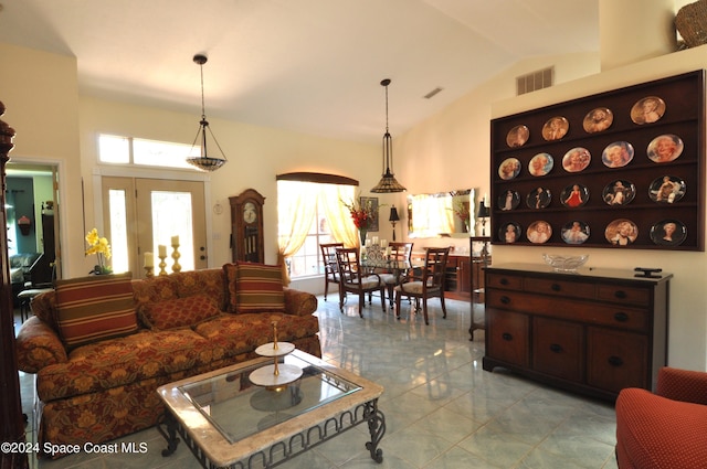 tiled living room featuring high vaulted ceiling