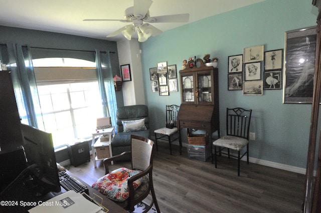 living area with dark hardwood / wood-style flooring and ceiling fan