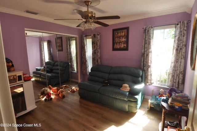 living room featuring hardwood / wood-style flooring, ceiling fan, and ornamental molding