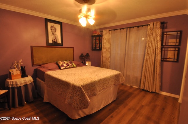 bedroom with hardwood / wood-style flooring, ceiling fan, and crown molding