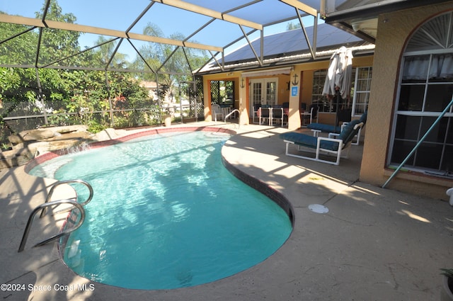 view of swimming pool featuring a patio area and french doors