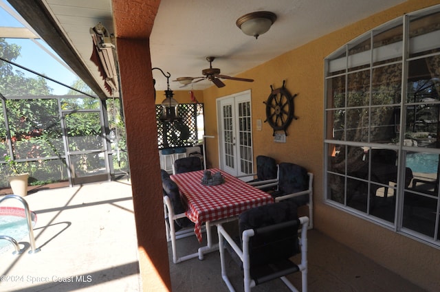 sunroom / solarium with ceiling fan and french doors