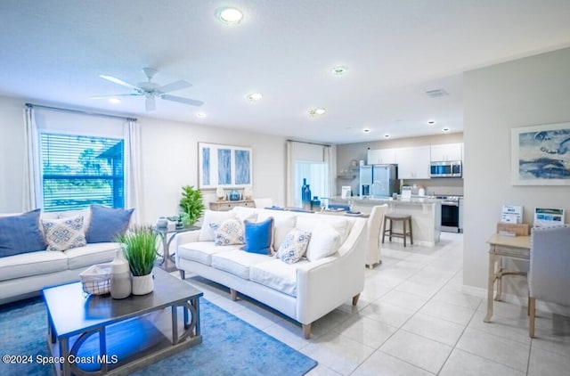 living room with light tile patterned floors and ceiling fan