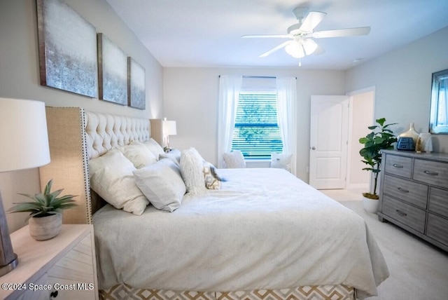 bedroom with light carpet and ceiling fan