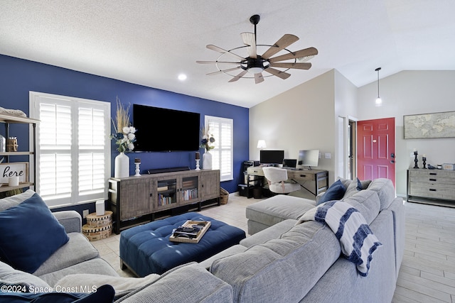 living room featuring light wood-type flooring, vaulted ceiling, plenty of natural light, and ceiling fan