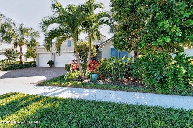 view of property hidden behind natural elements with a garage