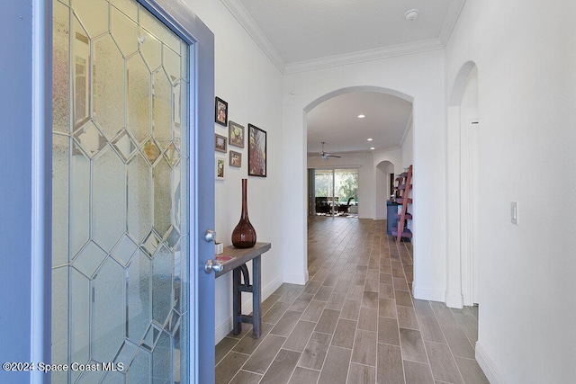 hallway featuring wood-type flooring and ornamental molding