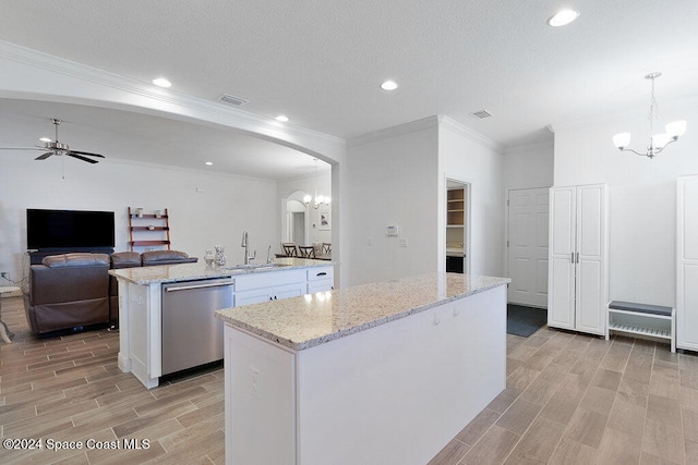 kitchen with stainless steel dishwasher, a center island, light stone countertops, and hanging light fixtures