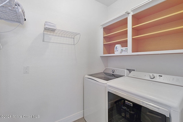 clothes washing area featuring separate washer and dryer