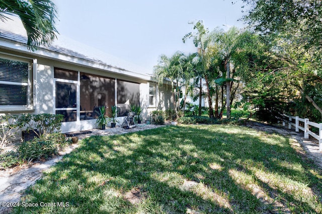 view of yard featuring a sunroom