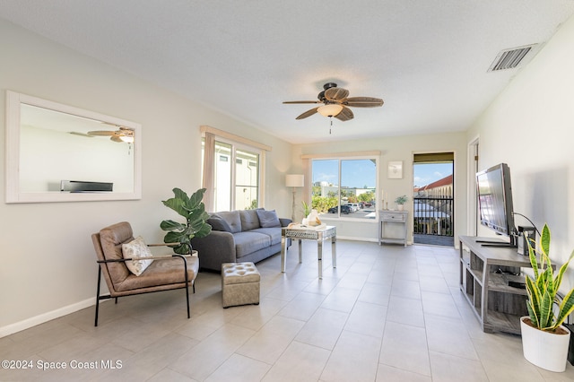 living room featuring light tile patterned floors and a textured ceiling