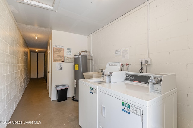 laundry area with separate washer and dryer, sink, and water heater