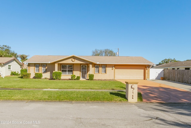 ranch-style house with a garage and a front lawn