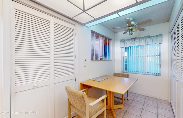 dining area with ceiling fan and light tile patterned flooring